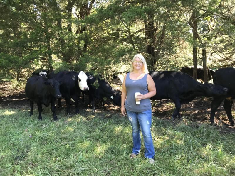 Holly Bickmeyer and cattle on the small farm she manages. She wants control over large livestock operations to stay local.