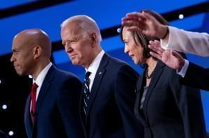 Democratic presidential hopefuls (from left): Sen. Cory Booker, D-N.J., former Vice President Joe Biden, and Sen. Kamala Harris, D-Calif., on stage before the July debate. 