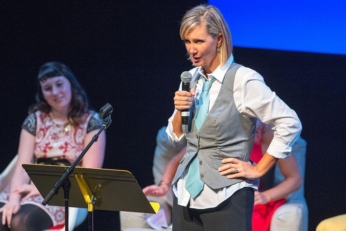 Kerry Rossow speaking to an audience using a microphone