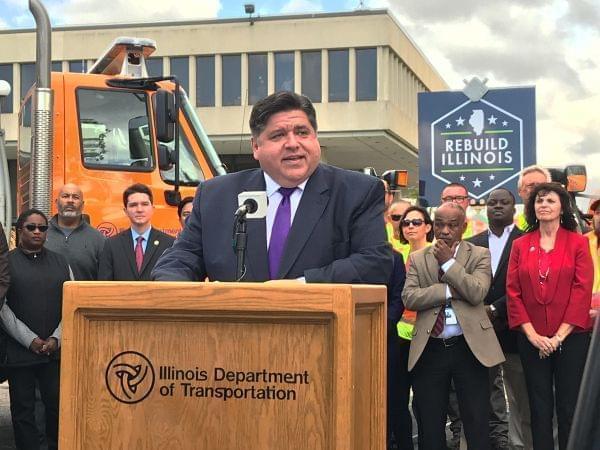 Flanked by state lawmakers and IDOT officials and workers, Gov. J.B. Pritzker announces details of statewide road and bridge construction at IDOT Headquarters in Springfield on Oct. 21