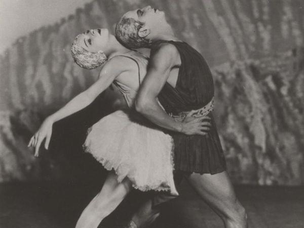 Two dancers perform on stage.