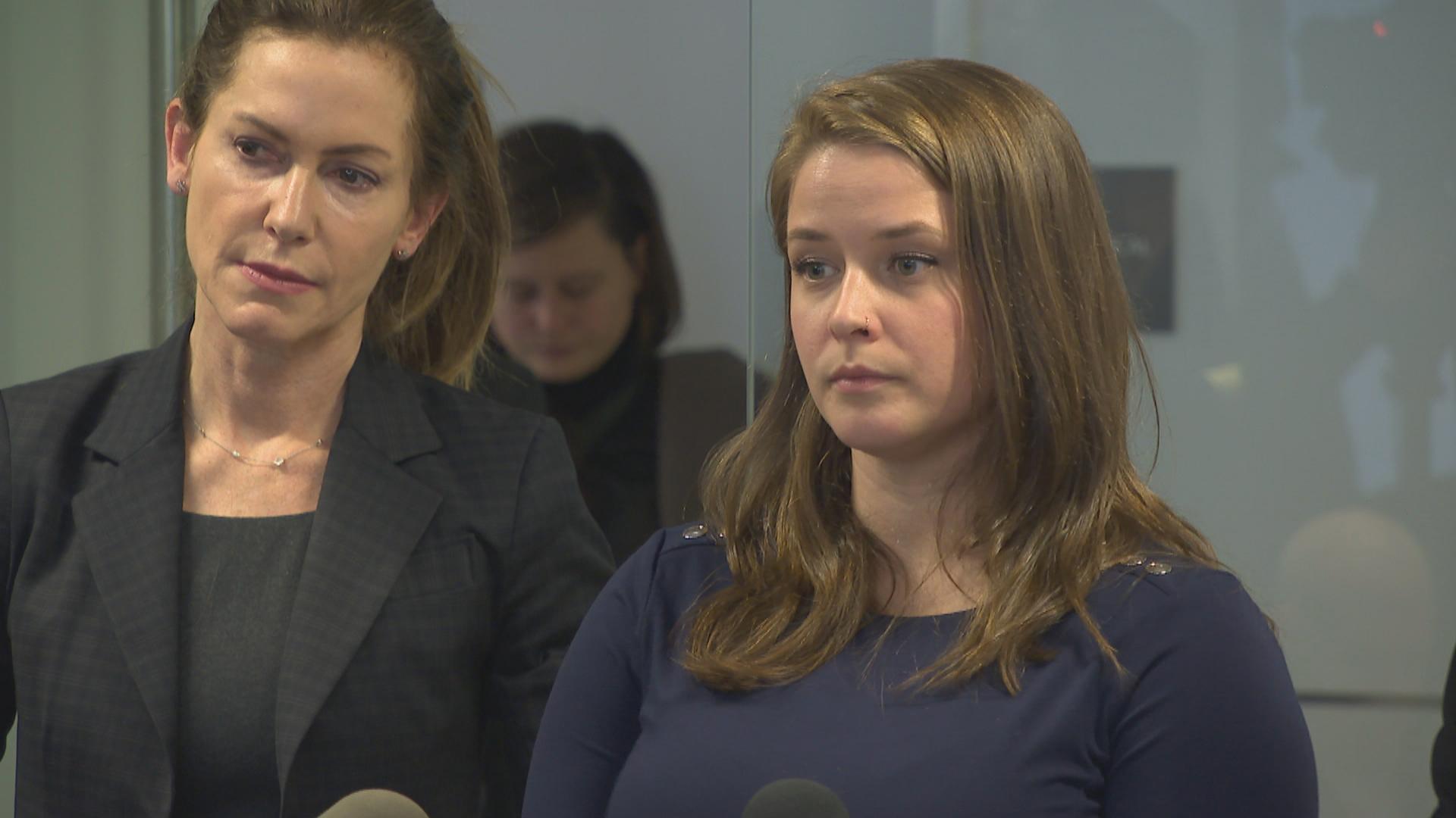 Alaina Hampton, right, speaks with reporters about her sexual harassment complaint in this file photo from 2018.