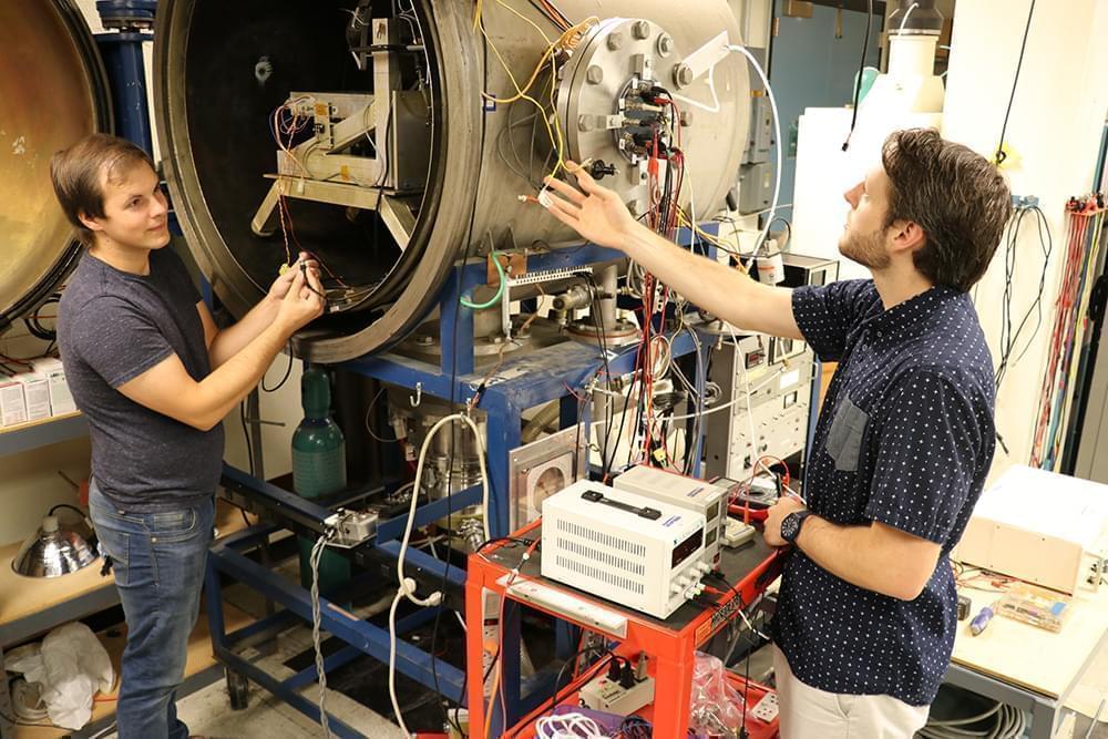 Aerospace engineering graduate students work with the vacuum chamber in Talbot Laboratory on the University of Illinois campus.