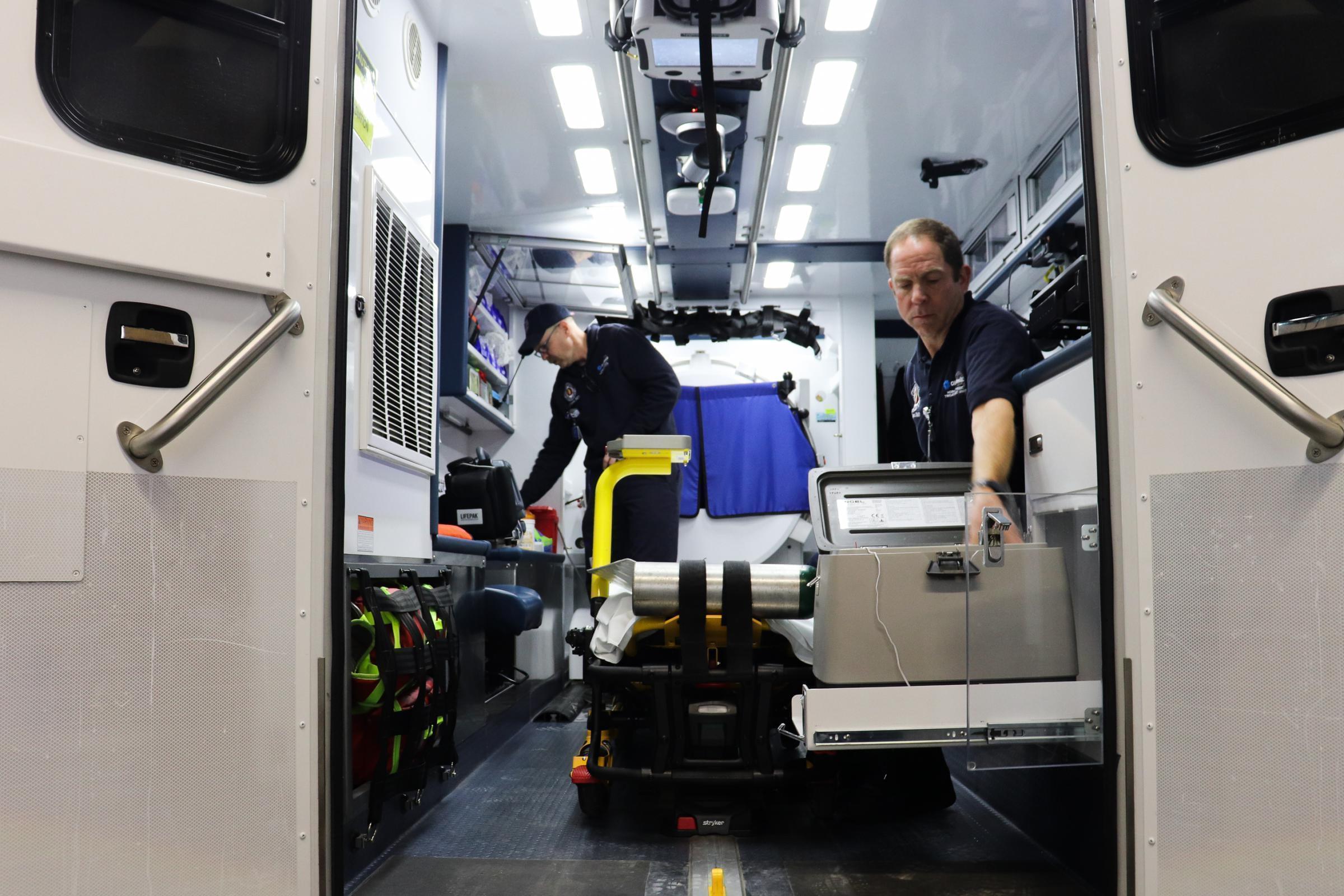 Paramedics Scott Widener and Mike Warnimont prepare the mobile stroke unit for the day.