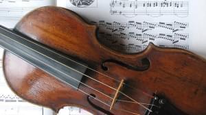 Violin sits on top of sheet music