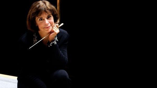 woman sitting on stage with baton