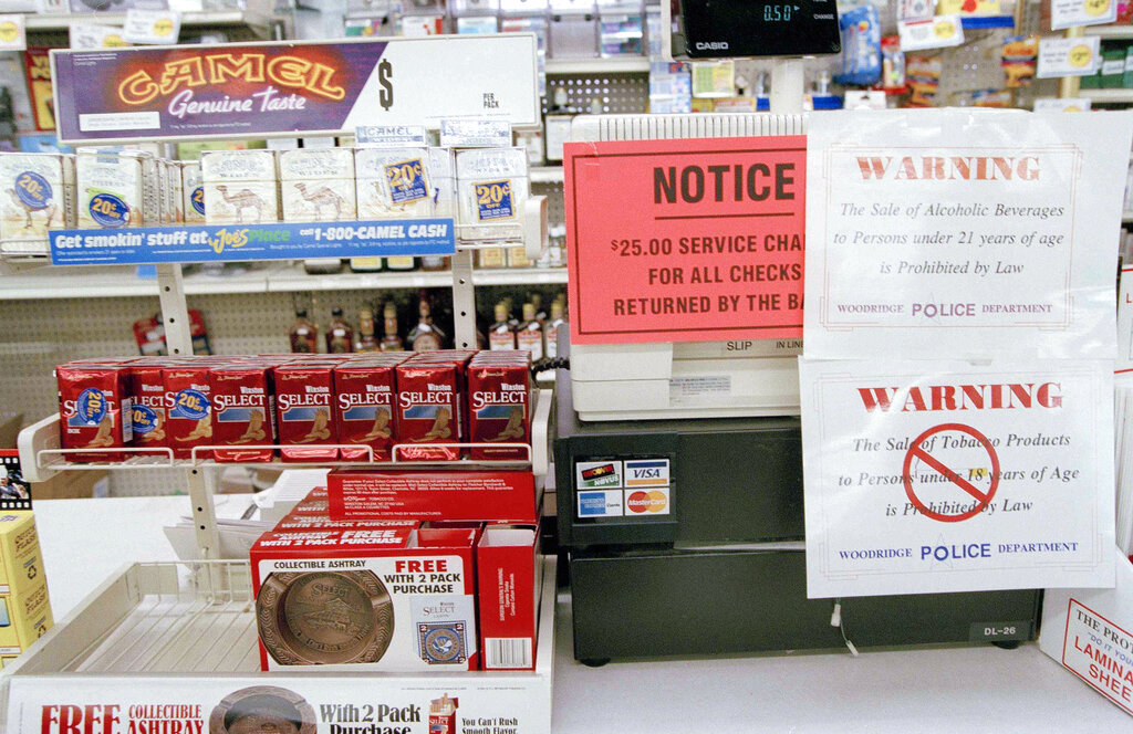 Tobacco products, along with signs warning of the local tobacco law, are displayed at a convenience store in Woodridge, Ill., Jan. 11, 1995. 