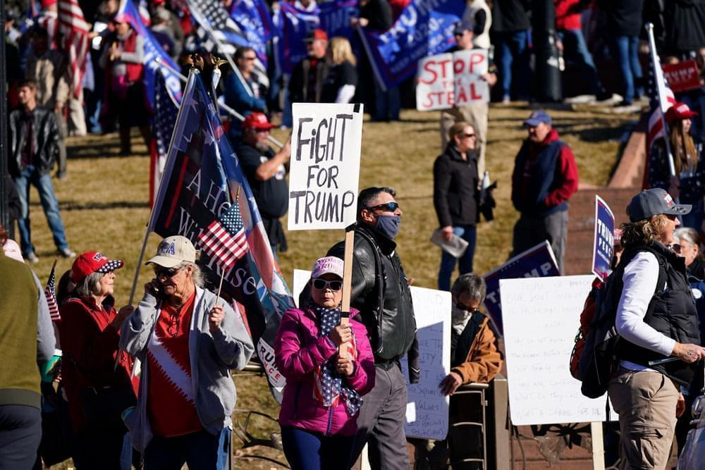 People attend a rally in support of President Donald Trump Wednesday, Jan. 6, 2021, outside the State Capitol in downtown Denver.