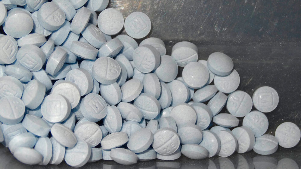 This undated file photo provided by the U.S. Attorneys Office for Utah and introduced as evidence at a trial shows fentanyl-laced fake oxycodone pills collected during an investigation.