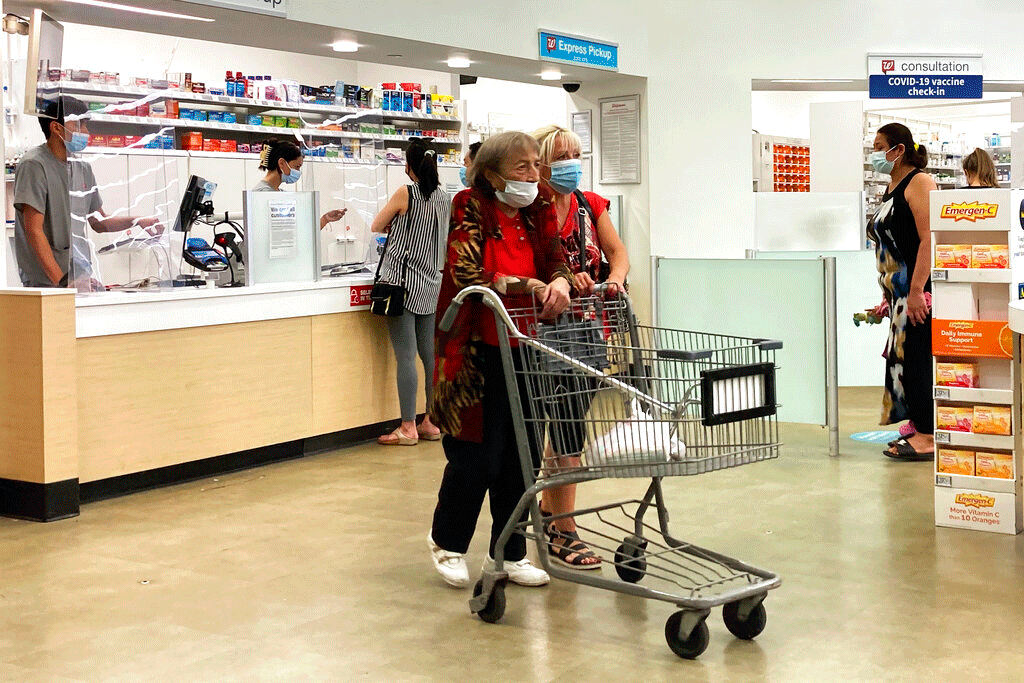 People wear mask inside of Walgreens in Wheeling, Ill., Wednesday, Aug.18, 2021.