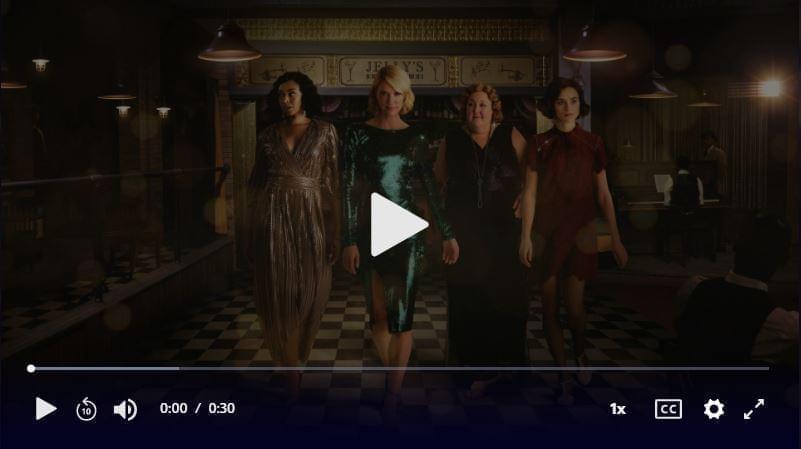 Four women walk through a bar, directly toward the camera. Click to play video.