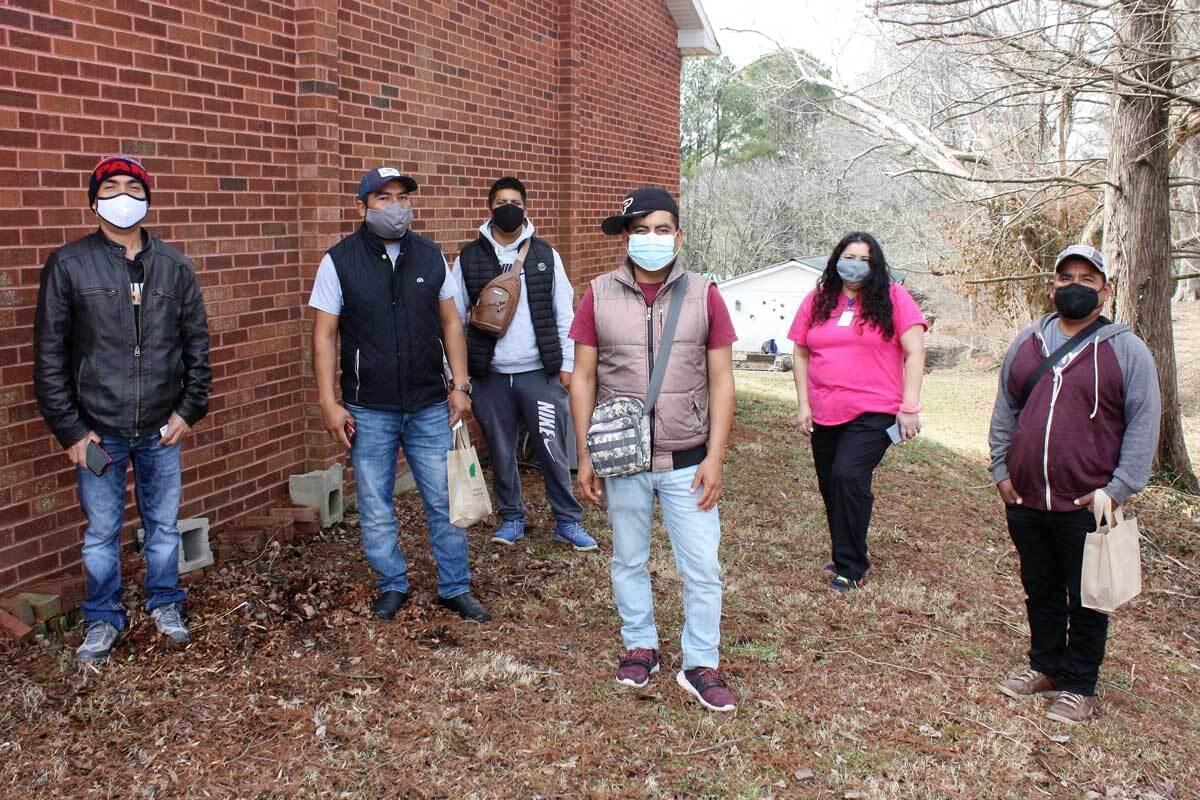 Karla Grathler, standing second from the right, leads the Farmworker Health Program at Shawnee Health Service. She poses alongside a group of migrant farmworkers from Oaxaca, Mexico, moments after getting they received the first dose of the vaccine on Feb. 27.