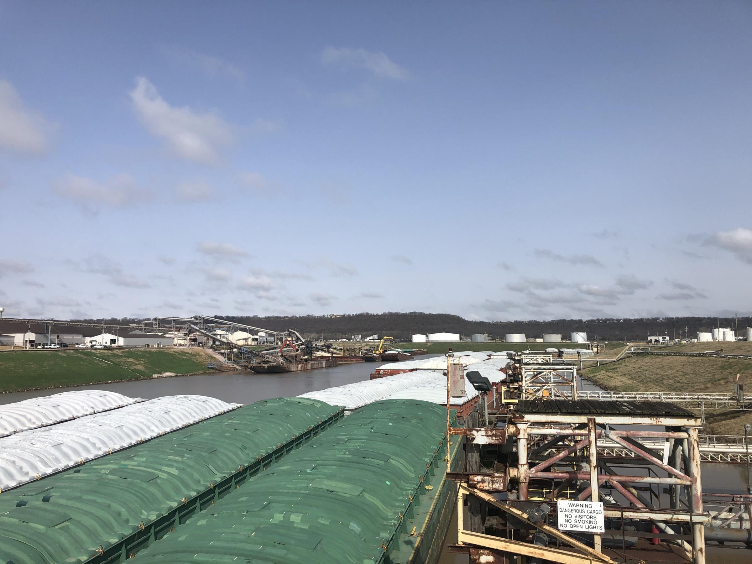 Barges float on the McClellan-Kerr Navigation system at the Port of Catoosa in Tulsa, OK. Barges hold 15,000 tons of soybeans, grain or fertilizer. Because of the lower costs and connection to the coast, farmers rely on the system.