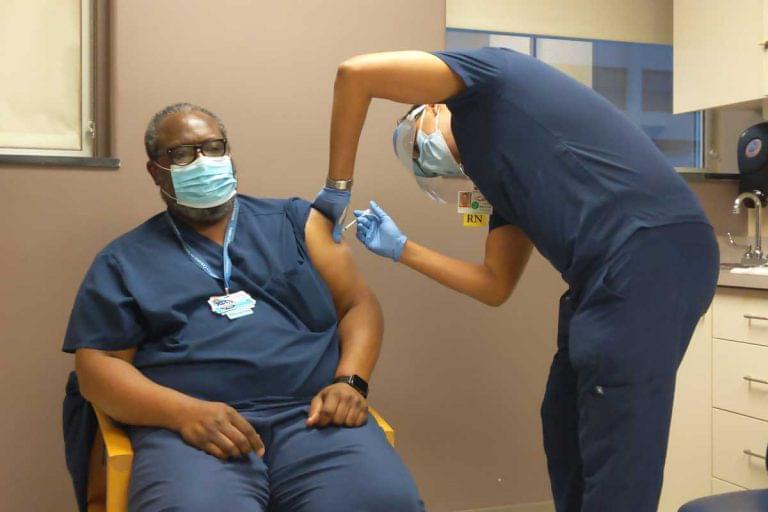 Trauma surgeon Uretz Oliphant was the first to receive the coronavirus vaccine at Carle Foundation Hospital in Urbana on Thursday, Dec. 17.