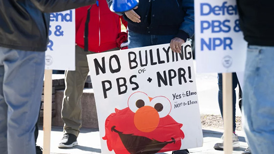 Picket signs in response to Trump's request to rescind funding for public broadcasting previously authorized by Congress.