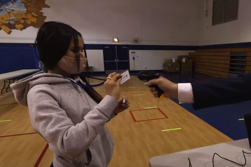 A student submits a saliva sample for coronavirus testing at Hillside School, which has been offering regular testing to students and staff since February 2021 in partnership with SHIELD Illinois.