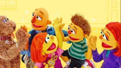 Picture of Julia from Sesame Street having fun with her family and high fiving her brother