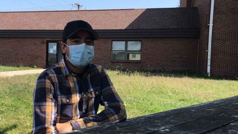 Samuel Gomez sits at the hotel where he and 100 or so other migrant farmworkers are living.
