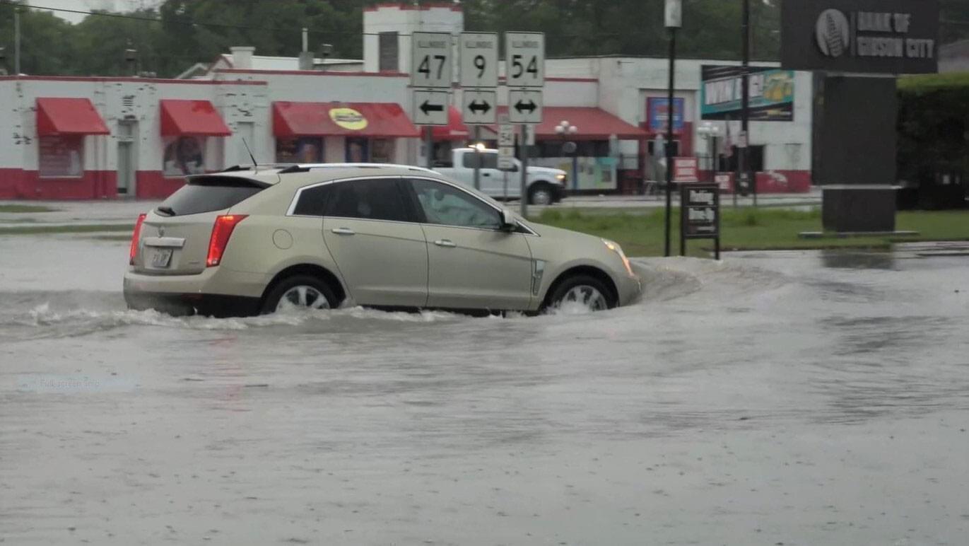 car driving in flood waters