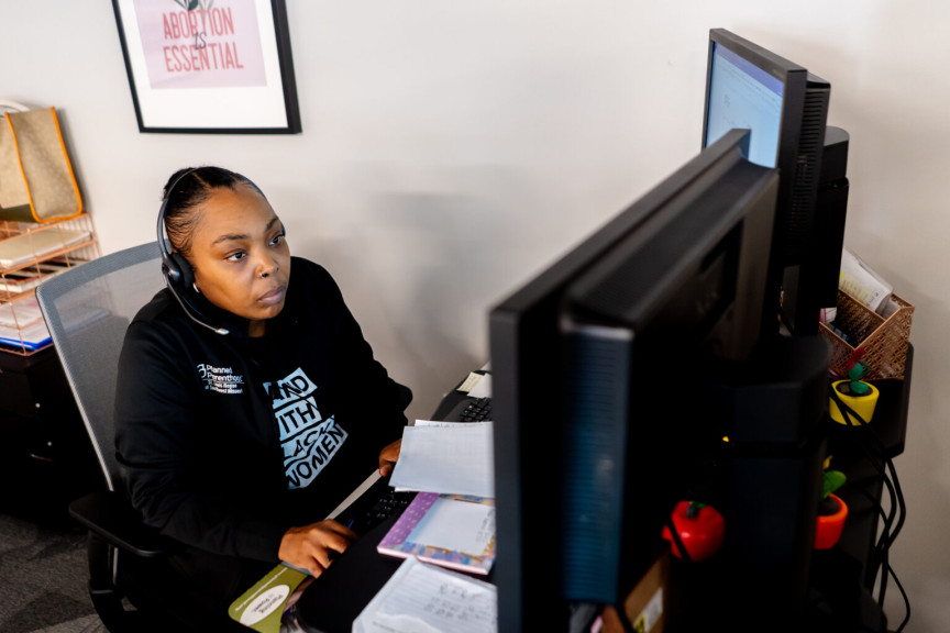 Kenicia Page, the regional logistics manager for Planned Parenthood of the St. Louis Region and Southwest Missouri, assists patients with finding funding for services in September at the organization's Fairview Heights clinic. 