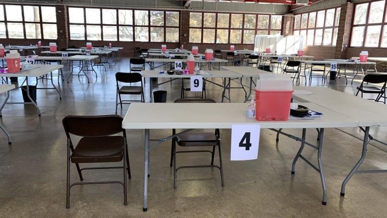 Dozens of tables with equipment for COVID-19 vaccinations sit in the Orr Building at the Illinois State Fairgrounds.