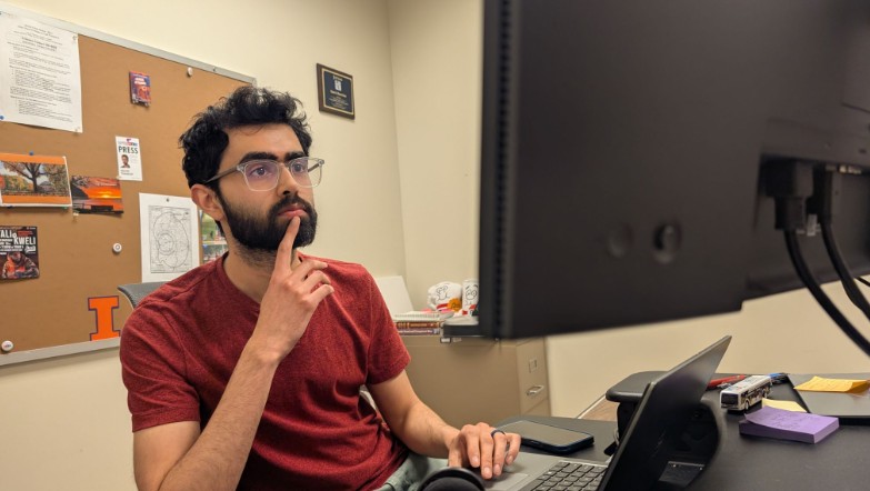 man sitting at computer