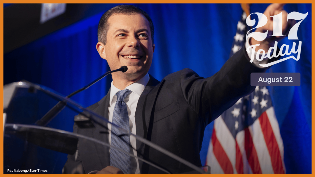 U.S. Secretary of Transportation Pete Buttigieg points to his husband during the Illinois Presidential Delegation’s breakfast at the Royal Sonesta Chicago Downtown in the Loop on the third day of the Democratic National Convention, Wednesday, Aug. 21, 2024.