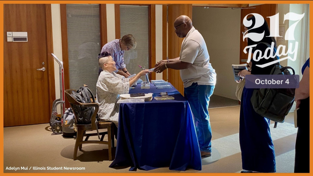 traci kato-kiriyama interacts with an audience member after their talk at the Spurlock Museum on Thursday, Sept. 26. She signed copies of her book, “Navigating With(out) Instruments.”