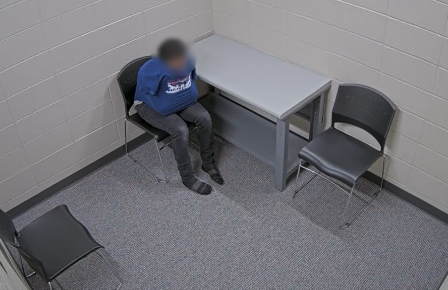 A screenshot from an interrogation video obtained by WBEZ shows a 15-year-old in a Waukegan police station — moments before detectives of that north suburb enter the room to interrogate him. The teen implicated himself in the Feb. 4, 2022, shooting of a Dollar General clerk. After the teen’s basketball team proved an alibi, prosecutors dropped charges. The video is spurring proposed changes to an Illinois law on juvenile interrogations.