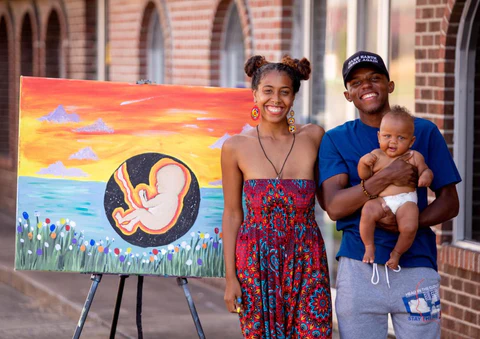 Co-founders Cree Sahidah Glanz and Marquez Scoggin alongside their daughter.