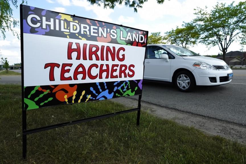A hiring sign is seen outside of a daycare building in Glenview, Ill., Saturday, May 22, 2021. Illinois ranks 41st for the lowest unemployment rate in the nation.