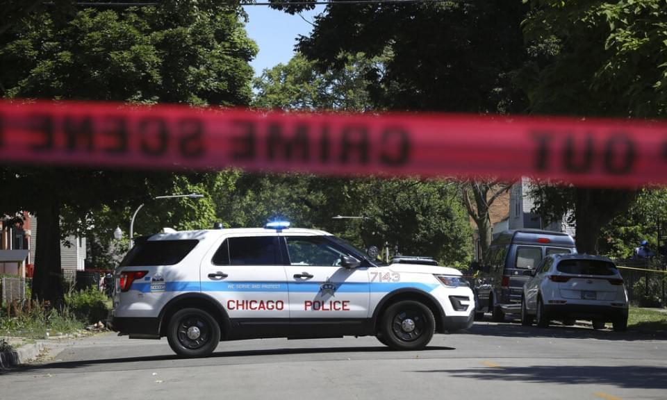 Police tape marks off a Chicago street as officers investigate the scene of a fatal shooting in the city's South Side on Tuesday, June 15, 2021.