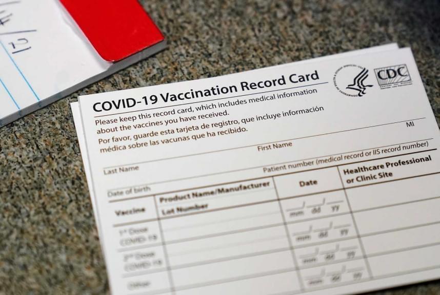 In this Dec. 24, 2020, file photo, a COVID-19 vaccination record card is shown at Seton Medical Center in Daly City, Calif.