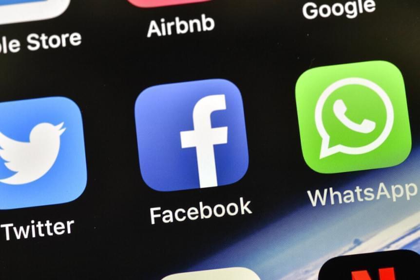  In this Nov. 15, 2018 file photo, the icons of Facebook and WhatsApp are pictured on an iPhone.