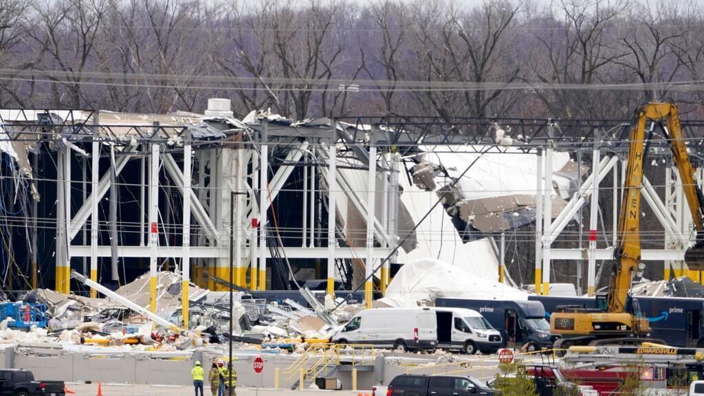 A heavily damaged Amazon fulfillment center is seen Saturday, Dec. 11, 2021, in Edwardsville, Ill. A large section of the roof of the building was ripped off and walls collapsed when strong storms moved through area Friday night.