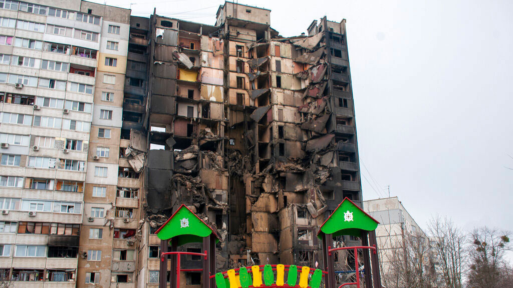 A children's playground is seen in front of an apartment building hit by shelling in Kharkiv, Ukraine, Tuesday, March 8, 2022.