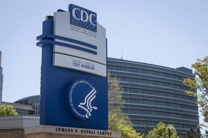 A sign at the entrance to the Centers for Disease Control and Prevention is seen, Tuesday, April 19, 2022, in Atlanta. The CDC on Friday said Champaign County is at a 