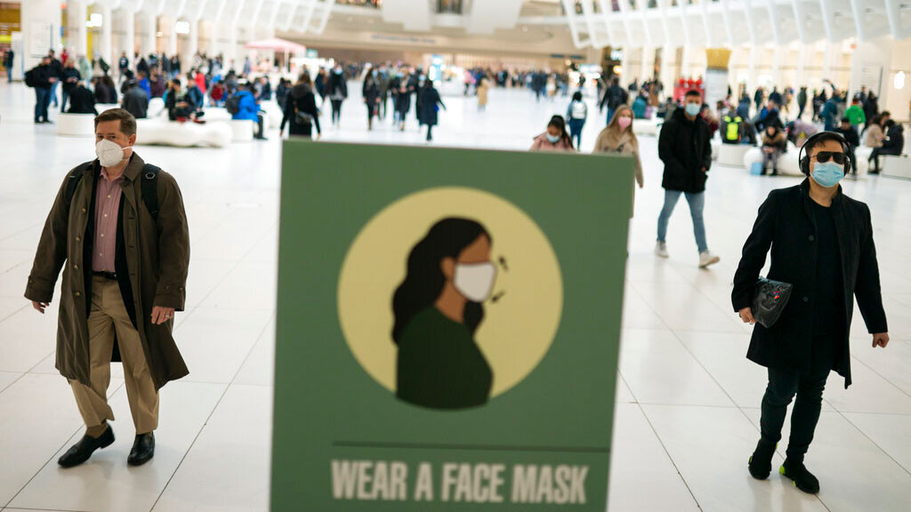 Mass transit riders wear masks as they commute in the financial district of lower Manhattan, Tuesday, April 19, 2022, in New York. The Justice Department is filing an appeal seeking to overturn a judge’s order that voided the federal mask mandate on planes and trains and in travel hubs. The notice came minutes after the Centers for Disease Control and Prevention asked the Justice Department to appeal the decision handed down by a federal judge in Florida earlier this week.