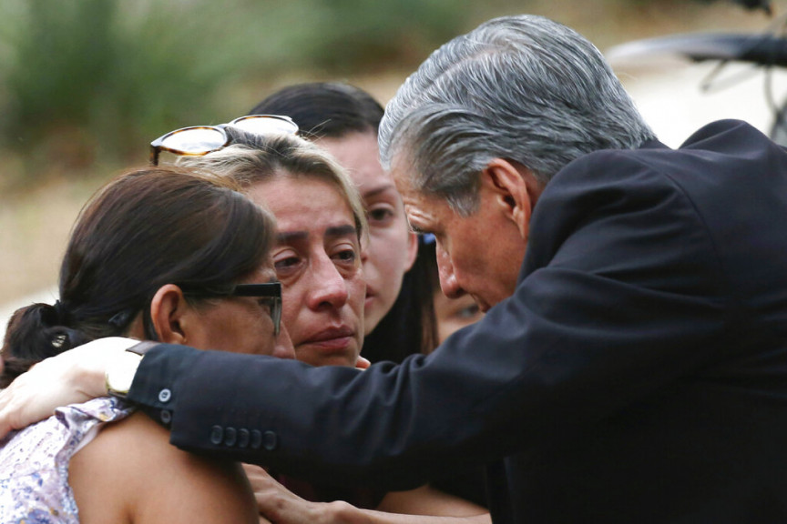 The archbishop of San Antonio, Gustavo Garcia-Siller, comforts families outside the Civic Center following a deadly school shooting at Robb Elementary School in Uvalde, Texas, Tuesday, May 24, 2022.