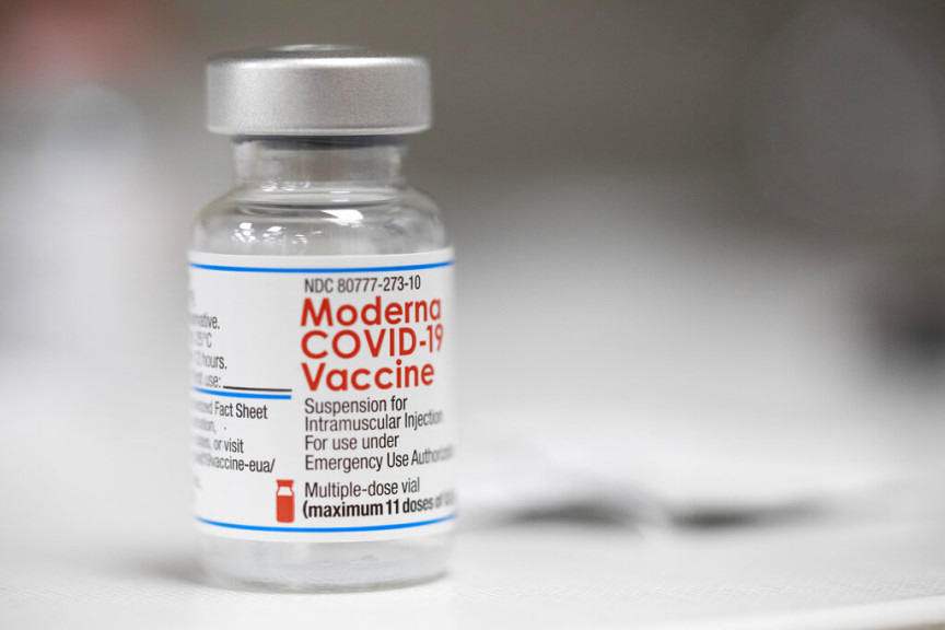 A vial of the Moderna COVID-19 vaccine is displayed on a counter at a pharmacy in Portland, Ore. on Dec. 27, 2021. 
