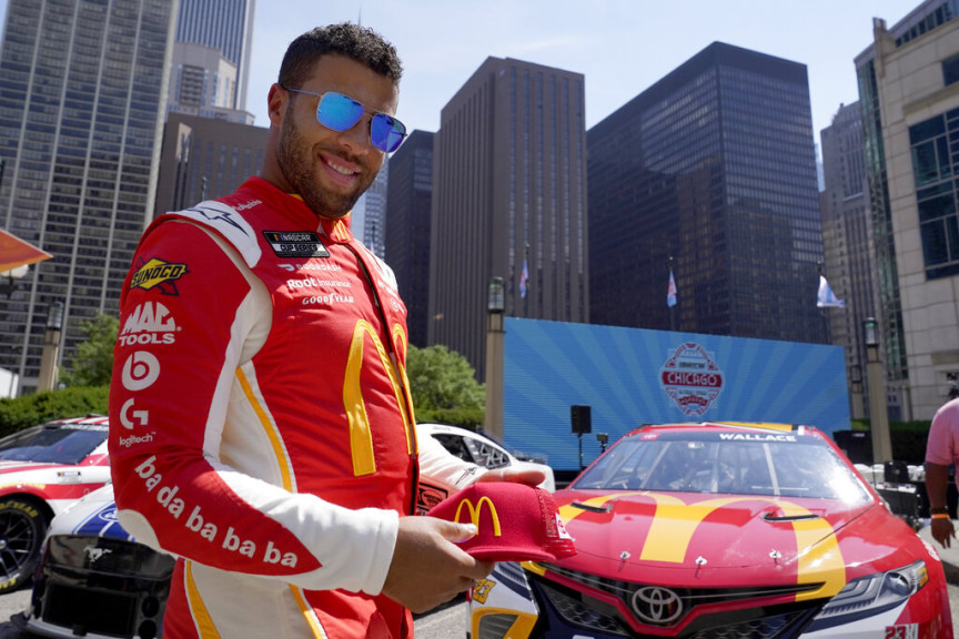 NASCAR driver Bubba Wallace poses for photographers on Tuesday, July 19, 2022, in Chicago during a promotional visit to announce a NASCAR Cup Series street race in the city, to be held July 2, 2023.