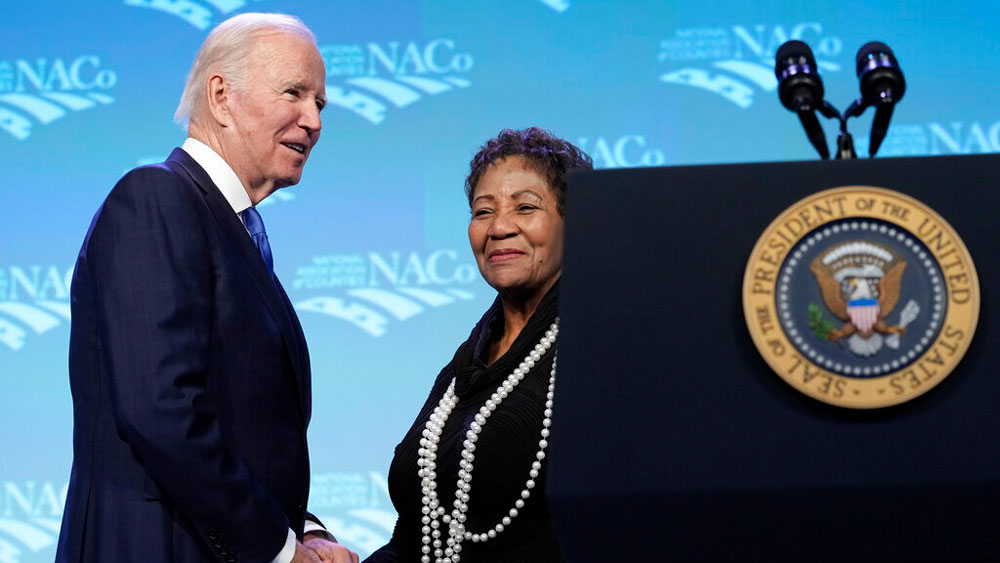 President Joe Biden, left, is introduced to speak by Will County, Illinois County Board Member and National Association of Counties President Denise Winfrey, right, at the National Association of Counties 2023 Legislative Conference in Washington, Tuesday, Feb. 14, 2023.