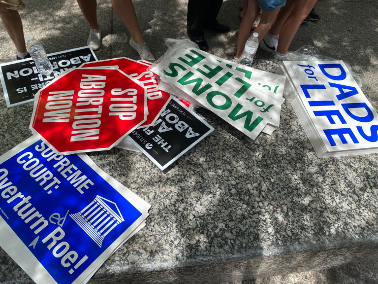 Abortion opponent signs on the ground at a rally in Chicago June 24, 2022.