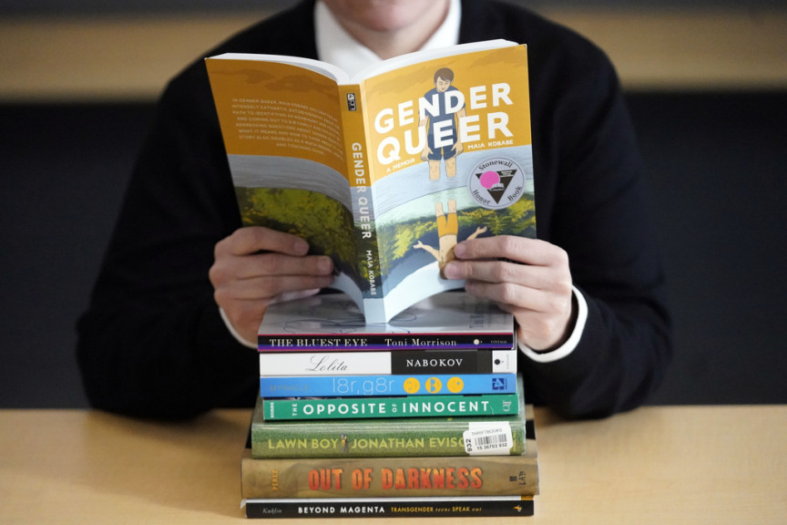 A pile of challenged books appear at the Utah Pride Center in Salt Lake City on Dec. 16, 2021. Attempted book bannings and restrictions at school and public libraries continue to surge, according to a new report from the American Library Association.