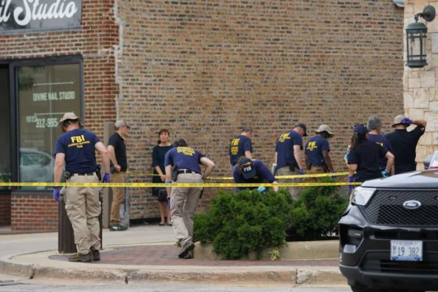 FBI personnel search for evidence in Highland Park Tuesday Morning.