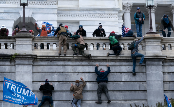 Supporters of President Donald Trump climb the West wall of the the U.S. Capitol on Wednesday, Jan. 6, 2021, in Washington.