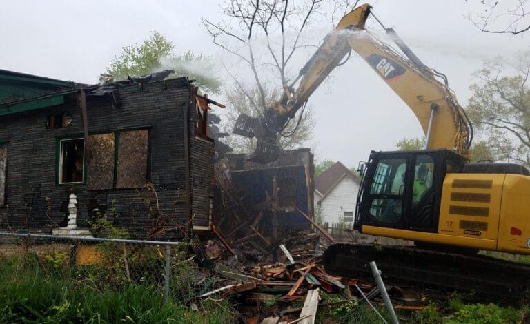 A house in Danville's Rabbittown neighborhood was torn down by a Public Works employee using a Caterpillar excavator, on April 28, as part of the city's building demolition program.