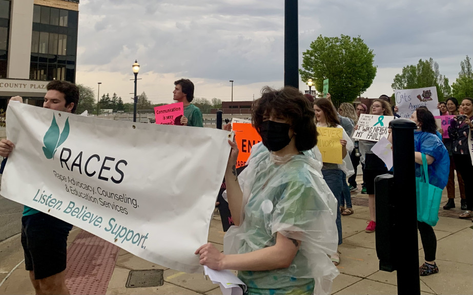 Dozens gather at the corner of Broadway Avenue in downtown Urbana for a rally that was held in support of Sexual Assault Awareness Month by Champaign-Urbana rape crisis centers.