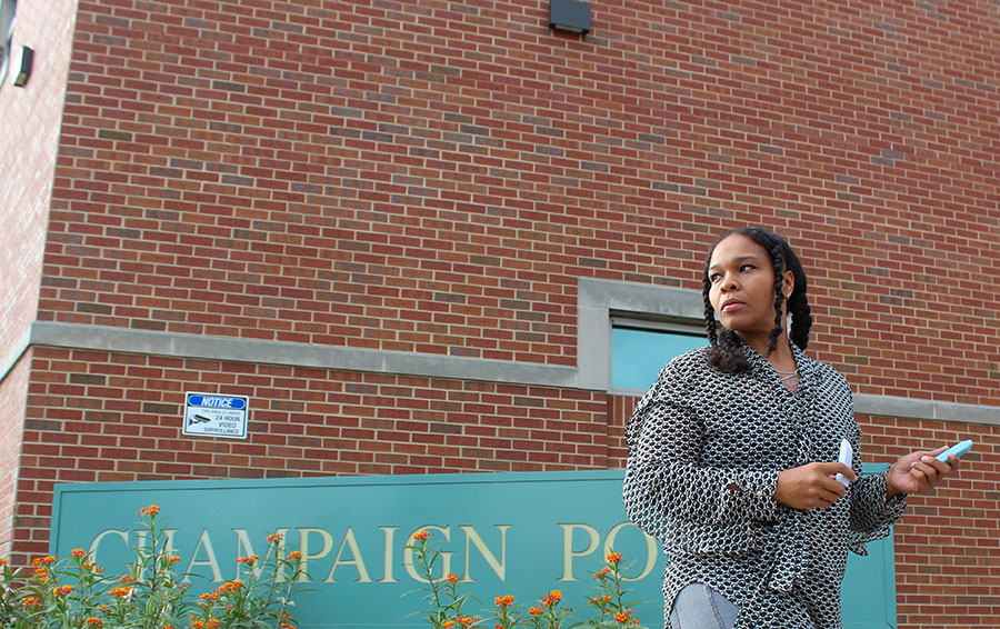 Champaign resident Rita Conerly holds chalk outside the Champaign Police Department building off University Avenue on September 28, 2023. Conerly wrote 