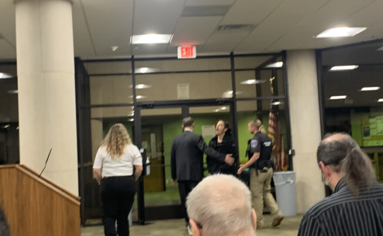 Police remove a protester from a recent Rockford School Board meeting. 